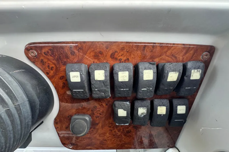 Slide: The Image of Control panel with switches on a 2003 Formula 37 Performance Cruiser boat. - 32