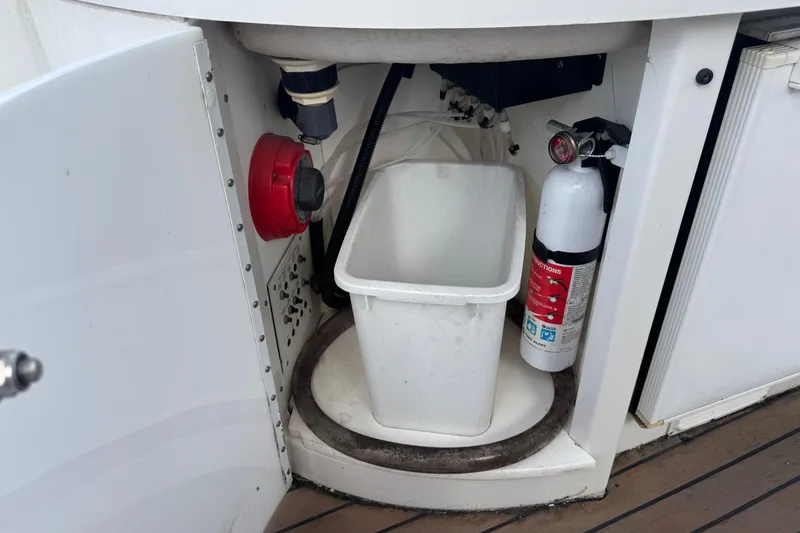 Slide: The Image of Storage compartment on a 2003 Formula 37 Performance Cruiser with fire extinguisher and trash bin. - 24