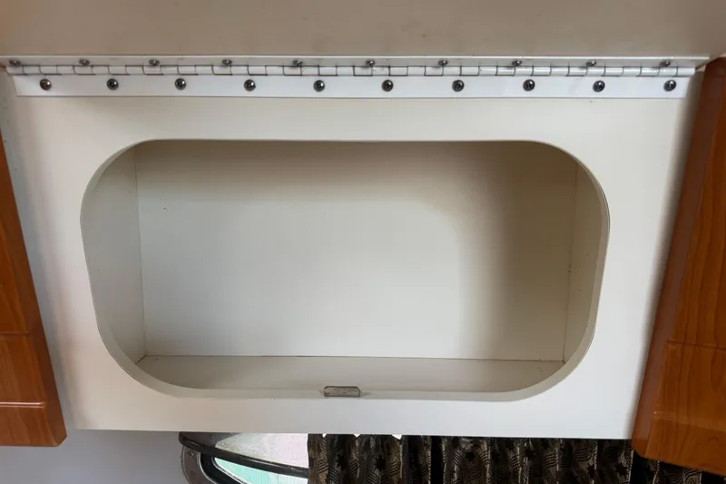 Slide: The Image of Empty storage compartment in a 2003 Formula 37 Performance Cruiser boat interior. - 43