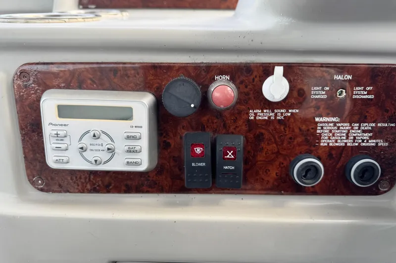 Slide: The Image of Control panel of a 2003 Formula 37 Performance Cruiser with audio system and safety warnings. - 31