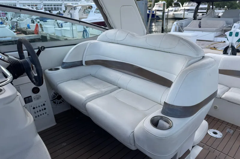 Slide: The Image of Interior of a 2003 Formula 37 Performance Cruiser with white leather seating and cup holders. - 63