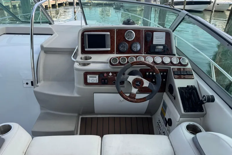 Slide: The Image of Helm of 2003 Formula 37 Performance Cruiser with gauges, steering wheel, and navigation equipment. - 29