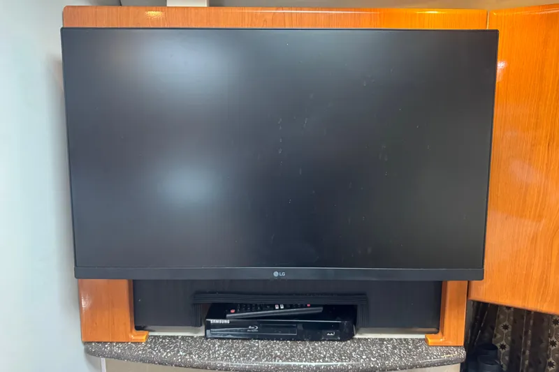 Slide: The Image of LG TV and Samsung Blu-ray player in a 2003 Formula 37 Performance Cruiser. - 49
