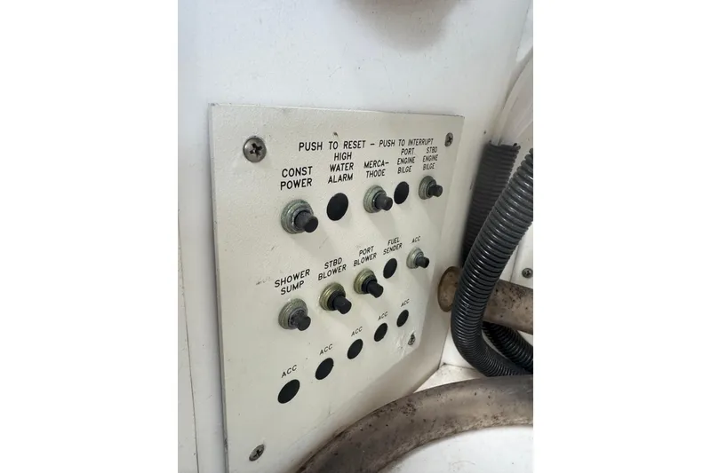 Slide: The Image of Control panel of a 2003 Formula 37 Performance Cruiser with various switches and labels. - 25