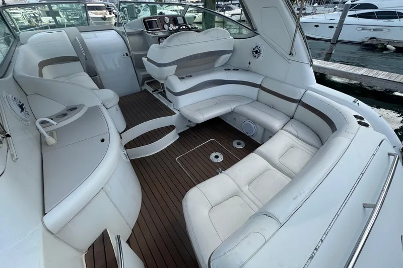 Slide: The Image of 2003 Formula 37 Performance Cruiser interior with white seating and wood flooring. - 18