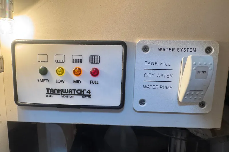 Slide: The Image of TankWatch 4 level monitor and water system controls on a 2003 Formula 37 Performance Cruiser. - 47