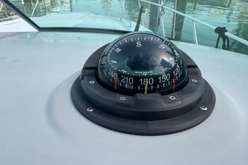 Slide: The Image of Compass on 2003 Formula 37 Performance Cruiser, docked with water reflections. - 39