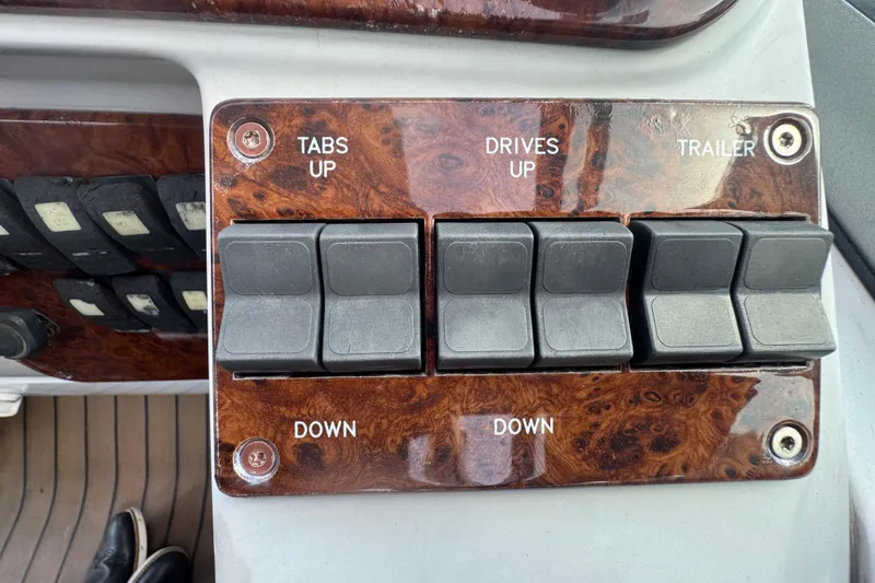 Slide: The Image of Control panel of a 2003 Formula 37 Performance Cruiser with switches for tabs, drives, and trailer. - 33