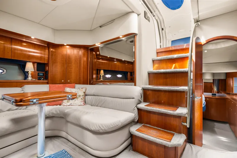 Slide: The Image of Luxurious interior of 2005 Cruisers Yachts 520 Express with elegant wood finishes and plush seating. - 14
