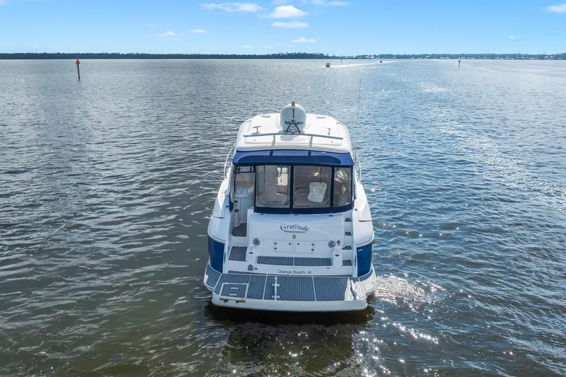 Slide: The Image of 2005 Cruisers Yachts 520 Express on open water, rear view. - 49