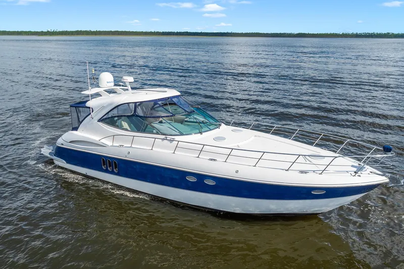 Slide: The Image of 2005 Cruisers Yachts 520 Express on open water, showcasing sleek design and luxury features. - 3