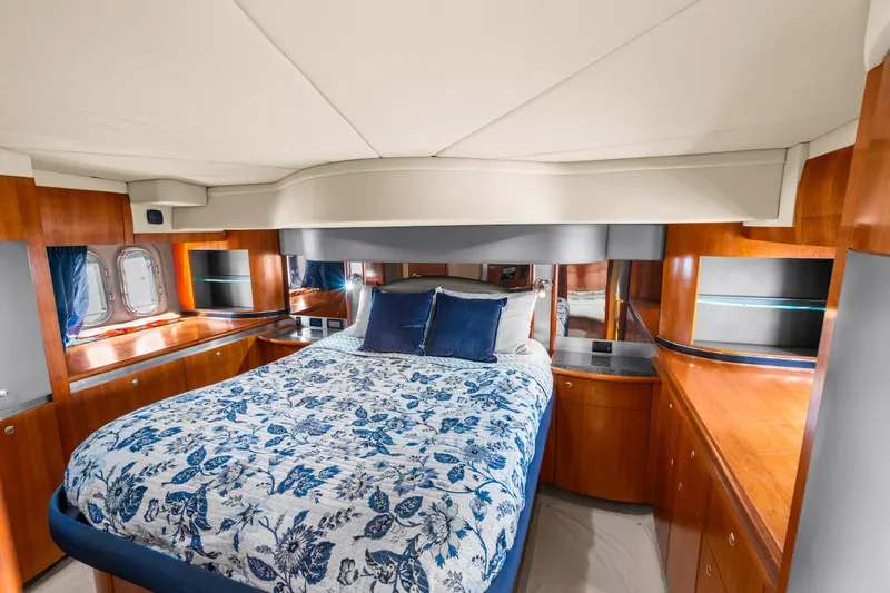 Slide: The Image of Luxurious 2005 Cruisers Yachts 520 Express cabin with elegant wood finish and floral bedding. - 16