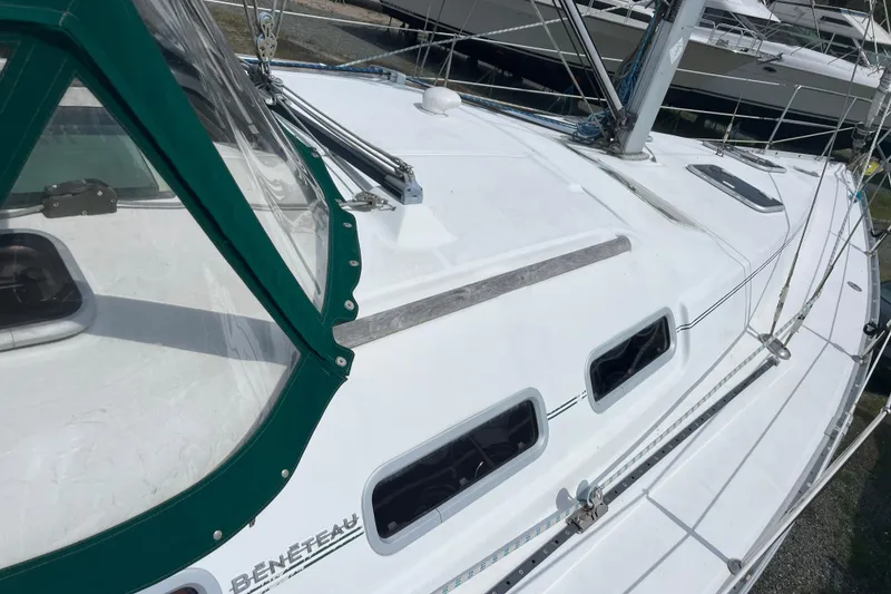 Slide: The Image of 2006 Beneteau Oceanis Clipper 373 sailboat deck with green canopy and sleek design. - 6