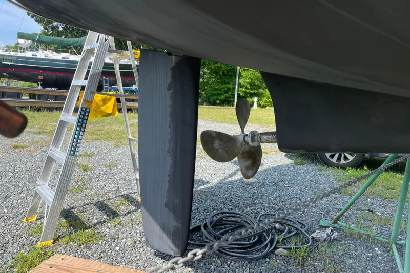 Slide: The Image of 2006 Beneteau Oceanis Clipper 373 sailboat propeller and rudder in dry dock. - 44