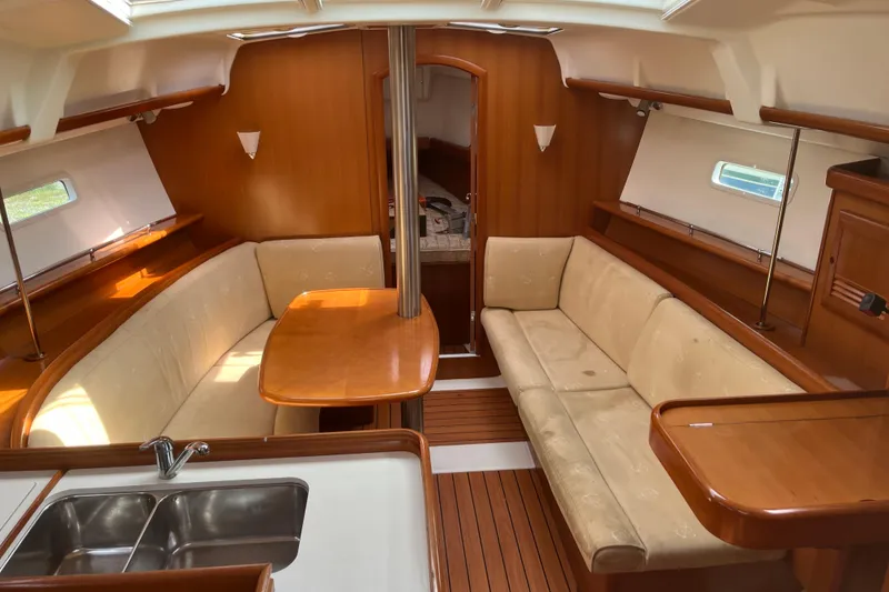 Slide: The Image of Interior of 2006 Beneteau Oceanis Clipper 373 yacht with cozy seating and wooden finishes. - 14