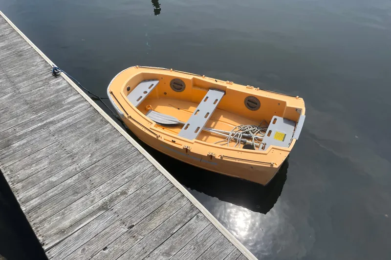 Slide: The Image of Small yellow boat docked on calm water beside a wooden pier. - 45