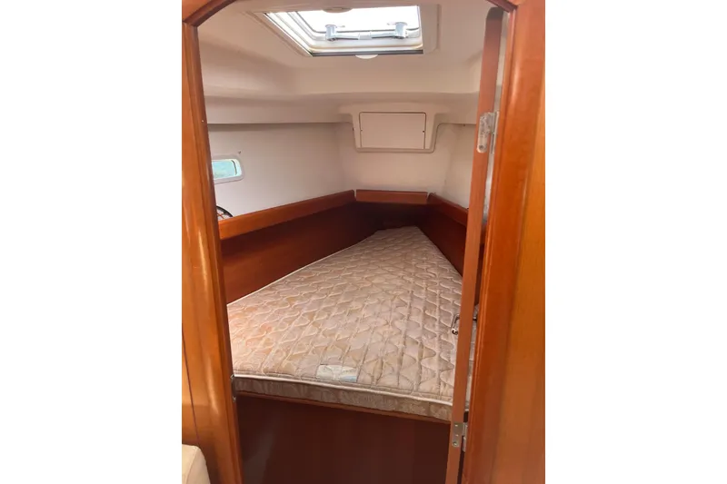 Slide: The Image of Interior cabin of 2006 Beneteau Oceanis Clipper 373 with mattress and wooden finish. - 22