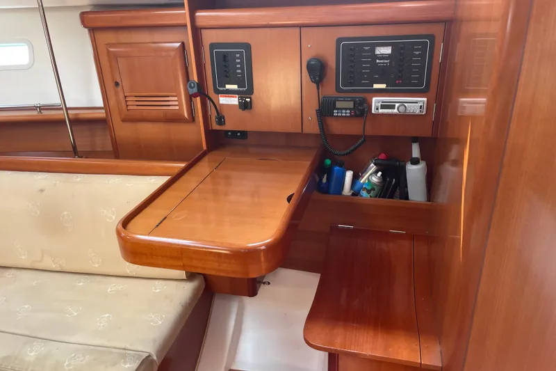 Slide: The Image of Interior of 2006 Beneteau Oceanis Clipper 373 yacht with navigation equipment and wooden cabinetry. - 26