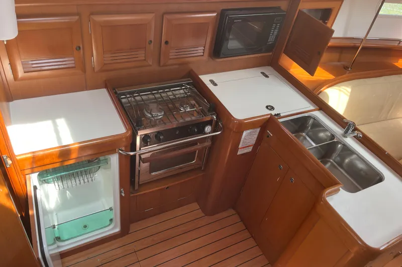 Slide: The Image of Galley kitchen in 2006 Beneteau Oceanis Clipper 373 yacht with stove, sink, and microwave. - 21