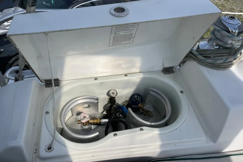 Slide: The Image of Open storage compartment on 2006 Beneteau Oceanis Clipper 373 sailboat, showing gas fittings and hoses. - 40