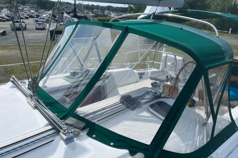 Slide: The Image of 2006 Beneteau Oceanis Clipper 373 sailboat with green canopy and clear panels in marina. - 11