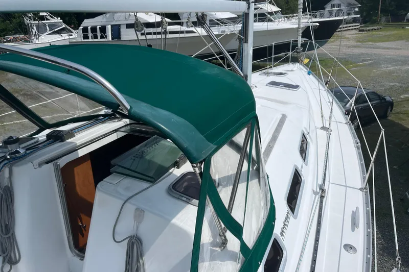 Slide: The Image of 2006 Beneteau Oceanis Clipper 373 sailboat with green canopy, docked on land. - 5