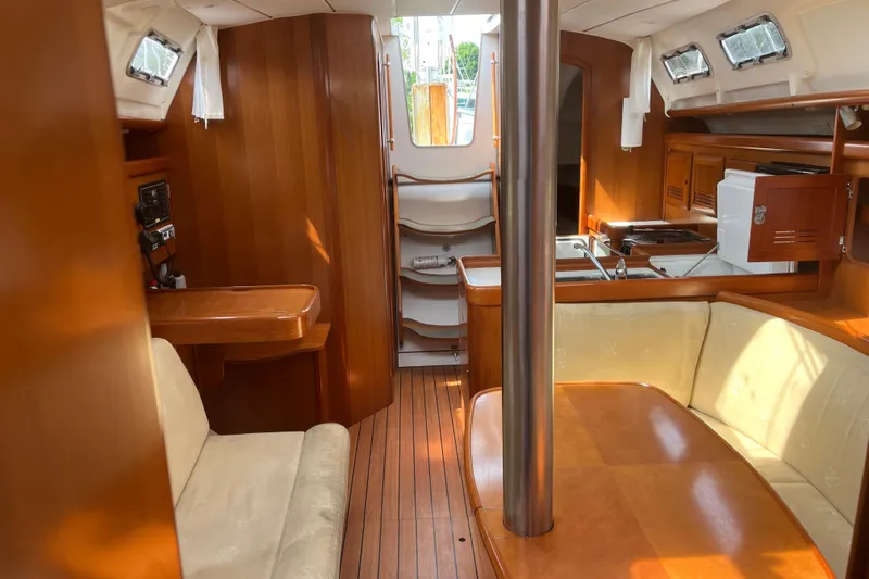 Slide: The Image of Interior of 2006 Beneteau Oceanis Clipper 373 sailboat with wood finish and cozy seating. - 24