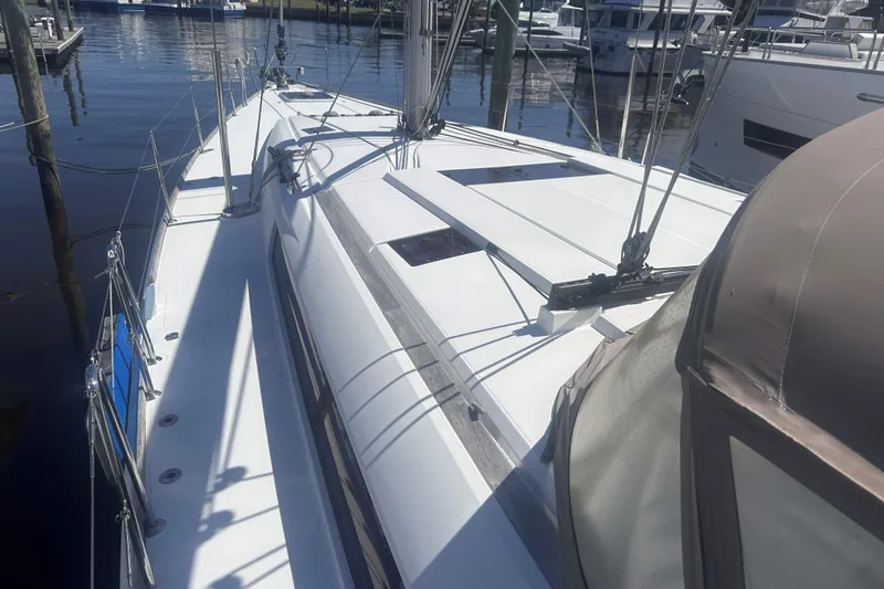 Slide: The Image of 2014 Jeanneau Sun Odyssey 509 sailboat docked at marina, showcasing sleek deck design. - 11