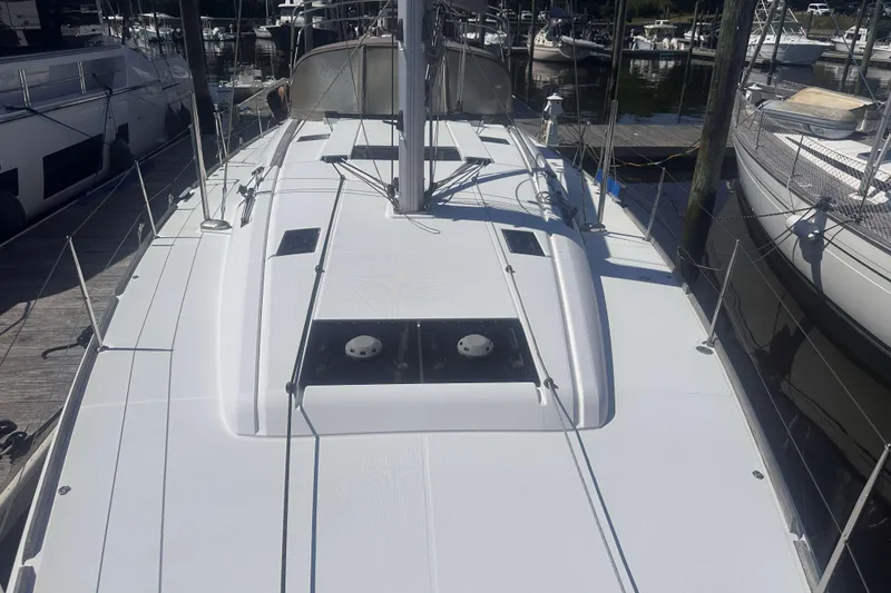 Slide: The Image of 2014 Jeanneau Sun Odyssey 509 sailboat docked at marina, showcasing sleek deck design. - 14