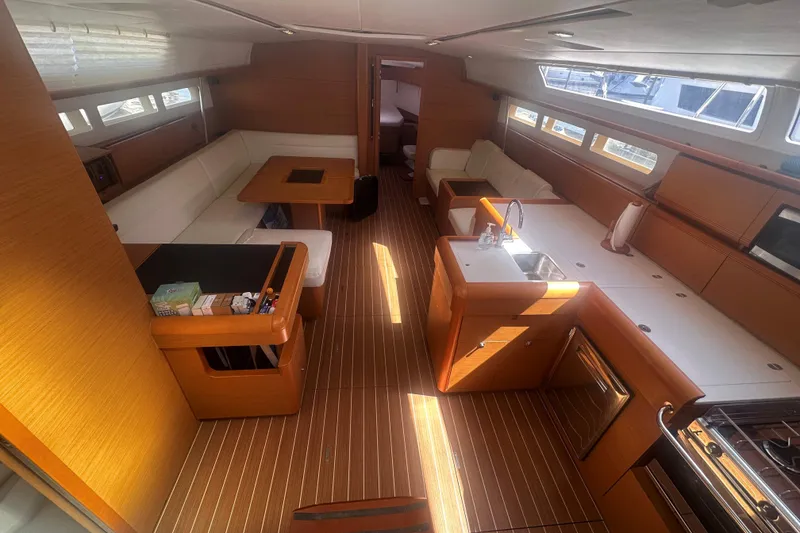 Slide: The Image of Interior of 2014 Jeanneau Sun Odyssey 509 yacht with modern kitchen and seating area. - 15