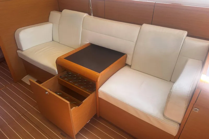 Slide: The Image of Luxurious interior of 2014 Jeanneau Sun Odyssey 509 with white seating and wooden storage. - 31