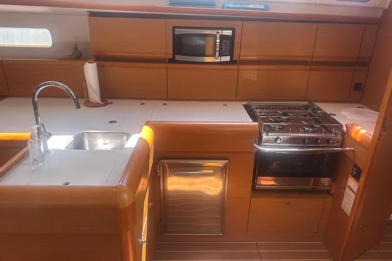 Slide: The Image of Modern kitchen in 2014 Jeanneau Sun Odyssey 509 yacht with stove, sink, and microwave. - 26