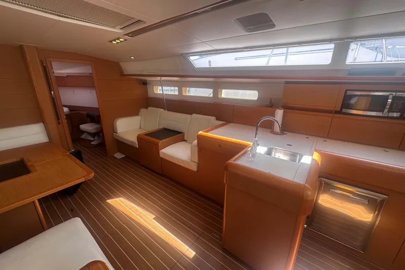 Slide: The Image of Luxurious interior of 2014 Jeanneau Sun Odyssey 509 yacht with modern kitchen and seating area. - 23