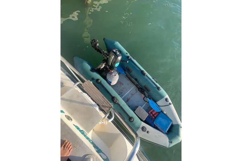 Slide: The Image of Inflatable dinghy with motor beside 1989 Silverton 46 Aft Cabin yacht. - 11