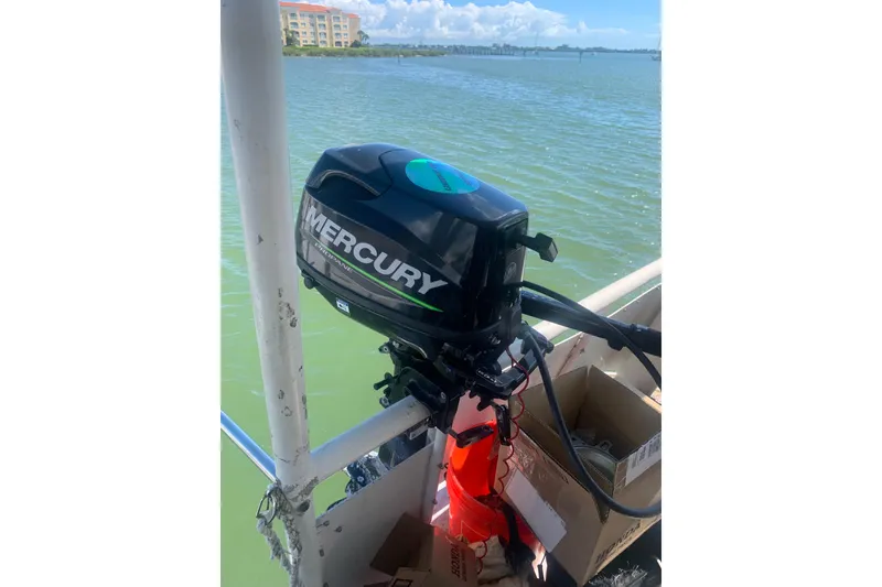 Slide: The Image of Outboard motor on a 1989 Silverton 46 Aft Cabin boat, overlooking calm waters. - 12