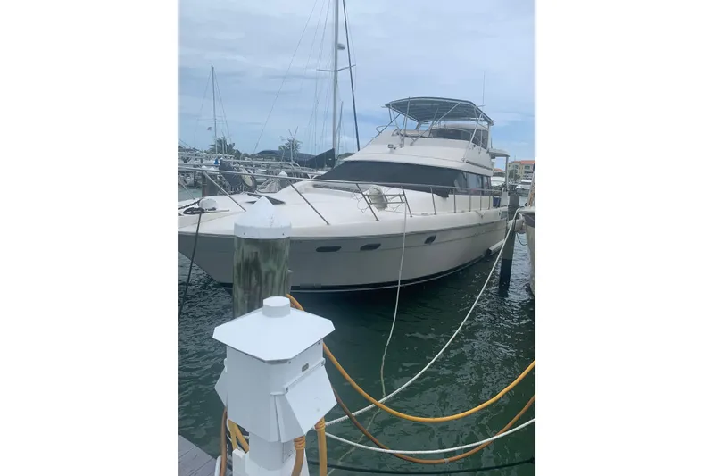 Slide: The Image of 1989 Silverton 46 Aft Cabin yacht docked at marina, featuring spacious design and classic style. - 2