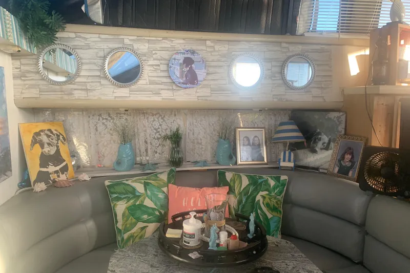 Slide: The Image of Cozy interior of a 1989 Silverton 46 Aft Cabin with decorative pillows and framed photos. - 7
