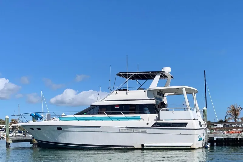 The Image of A 1989 Silverton 46 Aft Cabin yacht is docked on a sunny day. - 0