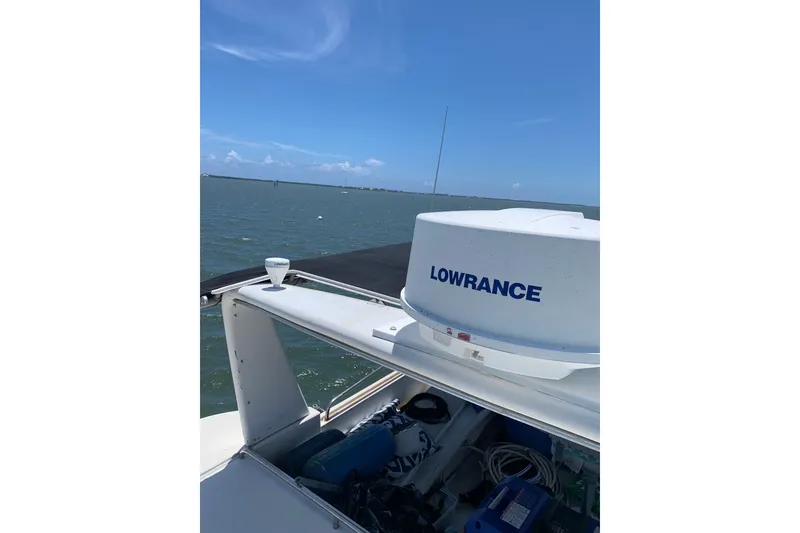Slide: The Image of 1989 Silverton 46 Aft Cabin boat with Lowrance equipment on open water. - 13