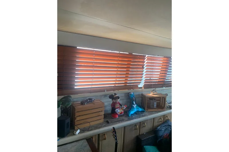 Slide: The Image of Interior of 1989 Silverton 46 Aft Cabin with wooden blinds and decorative items. - 8