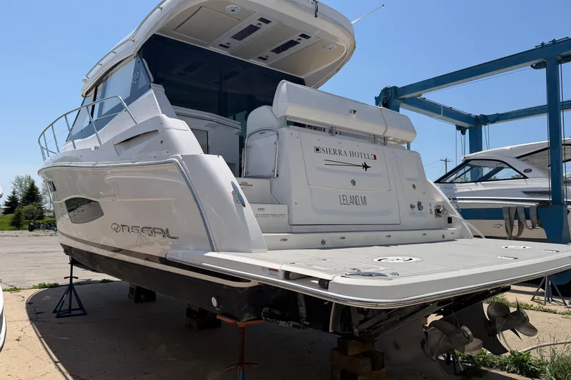 Slide: The Image of 2020 Regal 38 Grande Coupe yacht on dry dock, showcasing sleek design and modern features. - 6