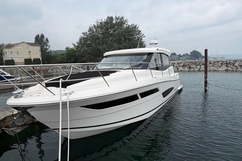 The Image of 2020 Regal 38 Grande Coupe yacht docked in a serene marina setting. - 0