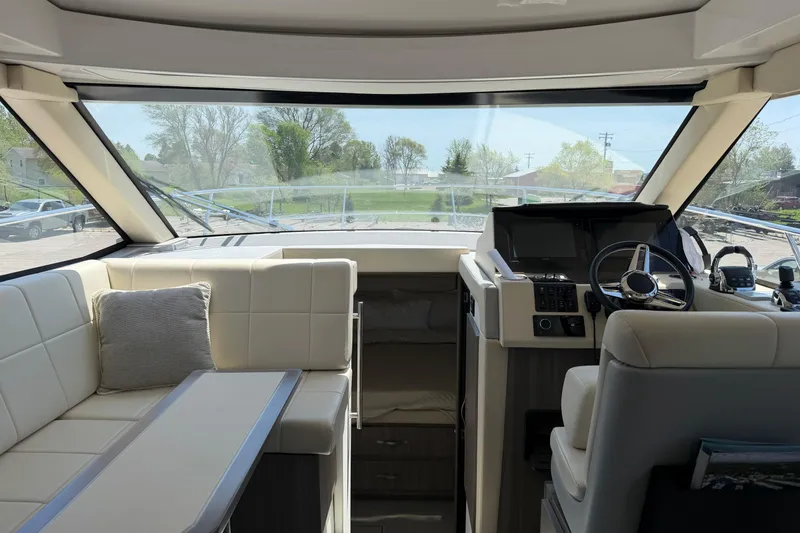Slide: The Image of Interior of 2020 Regal 38 Grande Coupe yacht with modern helm and seating area. - 19