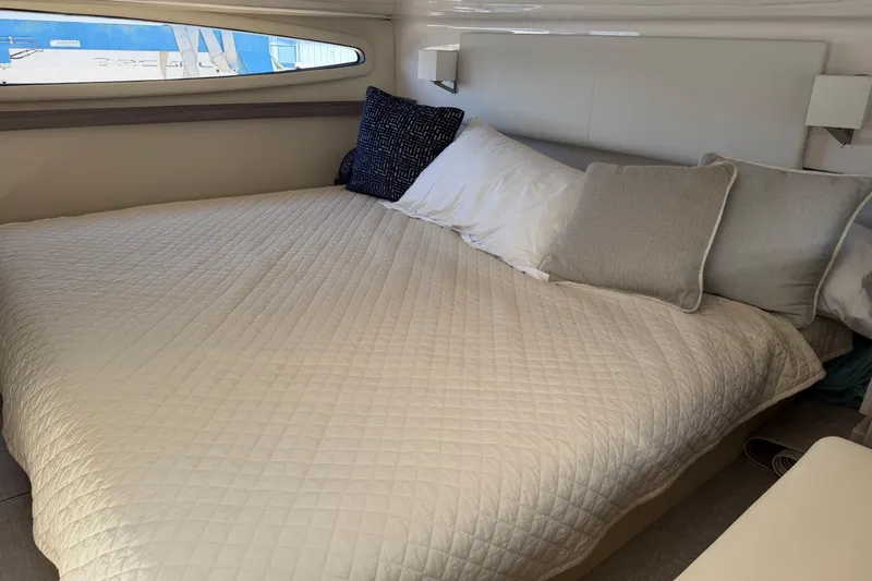 Slide: The Image of Luxurious cabin interior of 2020 Regal 38 Grande Coupe with cozy bedding. - 38