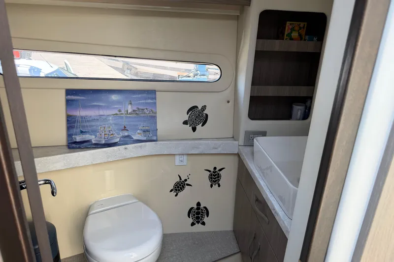 Slide: The Image of Interior of 2020 Regal 38 Grande Coupe bathroom with nautical decor and turtle decals. - 36