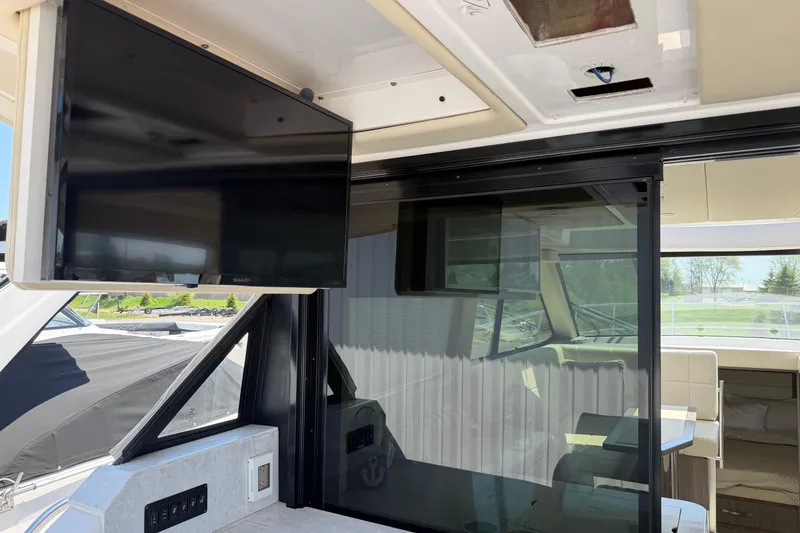 Slide: The Image of Interior of 2020 Regal 38 Grande Coupe featuring a mounted TV and sleek design elements. - 8