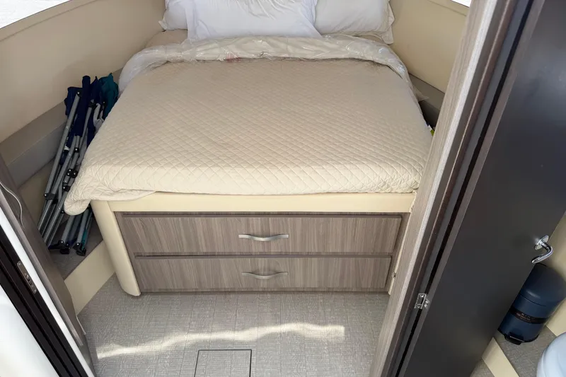 Slide: The Image of Cozy cabin interior of 2020 Regal 38 Grande Coupe with bed and storage drawers. - 30