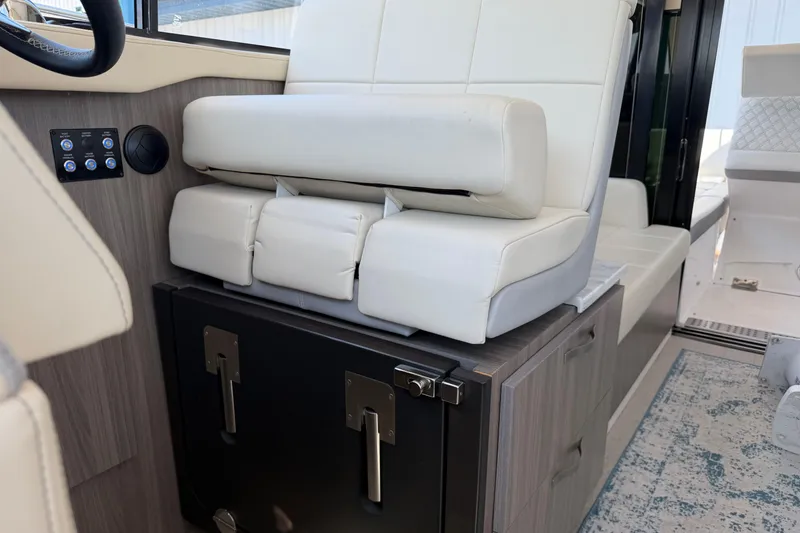 Slide: The Image of Interior of 2020 Regal 38 Grande Coupe with white leather seating and control panel. - 18
