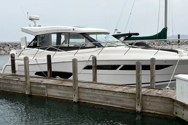 Slide: The Image of 2020 Regal 38 Grande Coupe yacht docked at a marina, side view. - 1