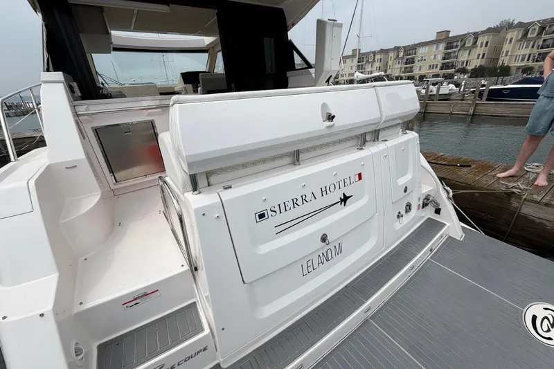 Slide: The Image of 2020 Regal 38 Grande Coupe yacht docked, featuring "Sierra Hotel" signage, Leland, MI. - 4